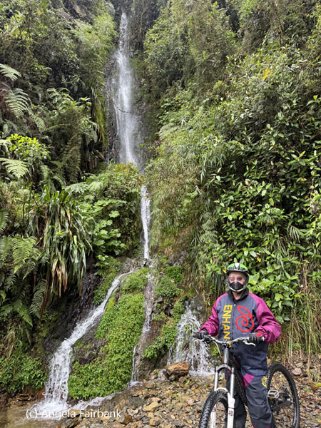 me on bike by waterfall on death road