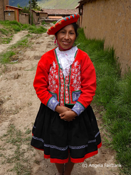 girl outside hut in ceramics village 3