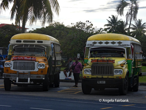 two painted wooden buses