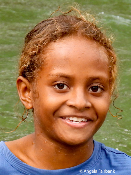 younger girl in lightblue t-shirt in water