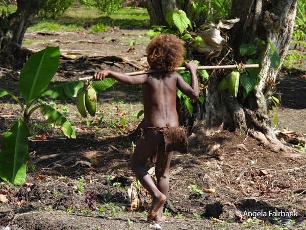 boy walking away with stick