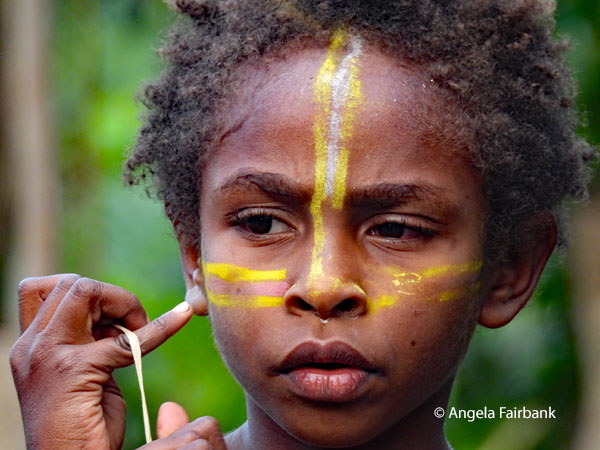 girl with yellow face paint
