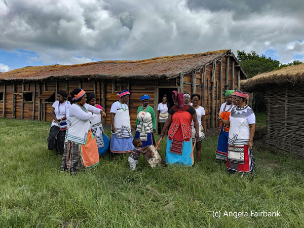 women outside huts