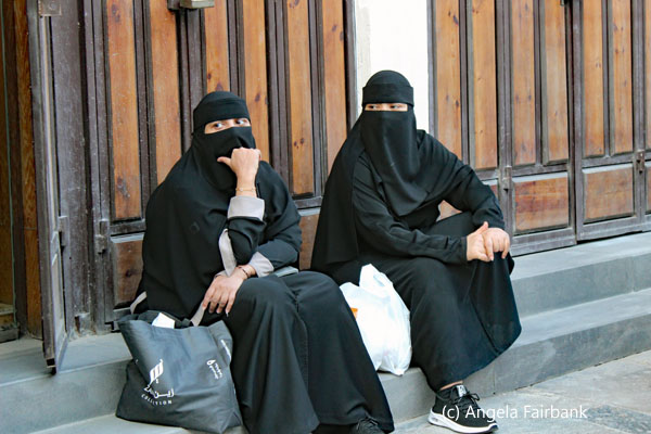 two women in black sitting
