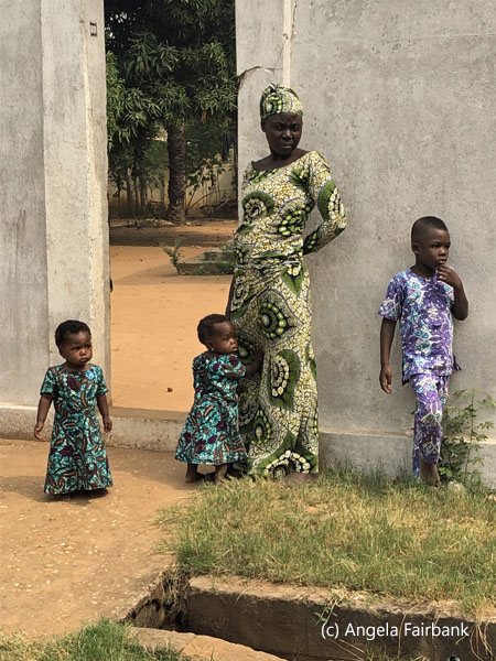 woman with 3 children at door