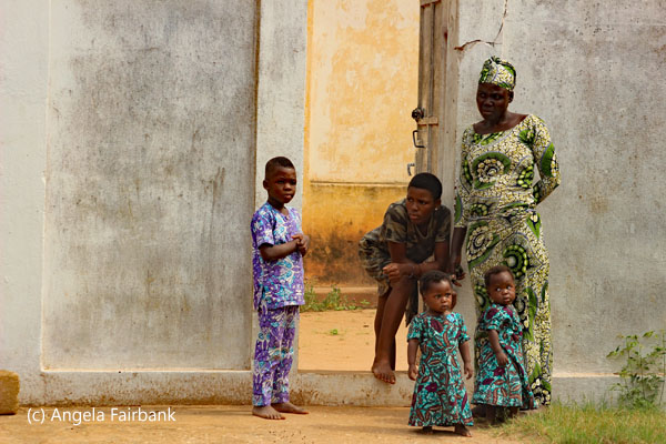 2 women with 3 children at door