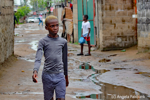 boy un grey walking in Mafalala