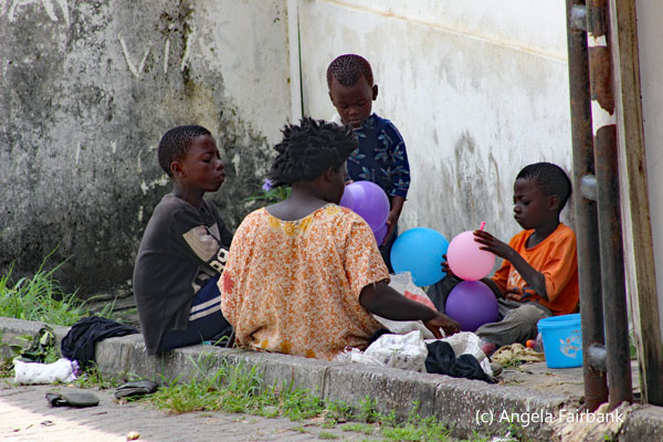 family blowing balloons