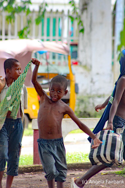 boy swinging green shirt