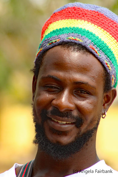 smiling young man in rasta cap