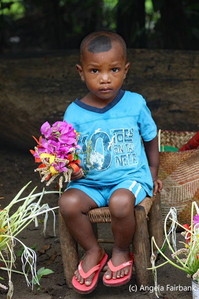 little boy in blue with flowers