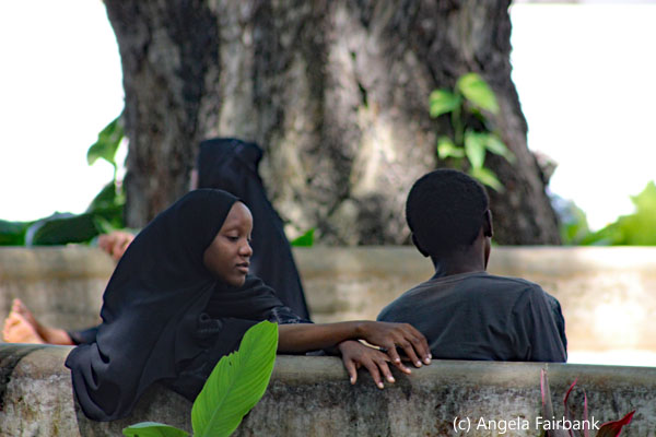 muslim woman and boy on bench