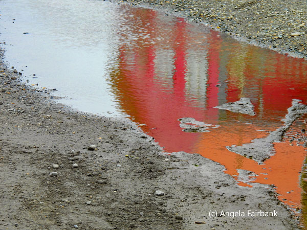 house reflected in puddle