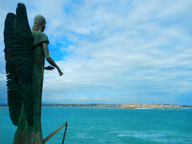 angel at resort with ortigia in background